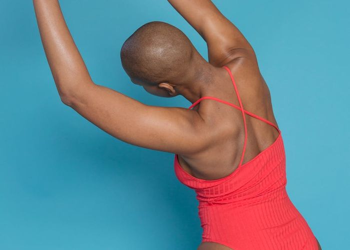 Woman stretching her back in a bright studio space